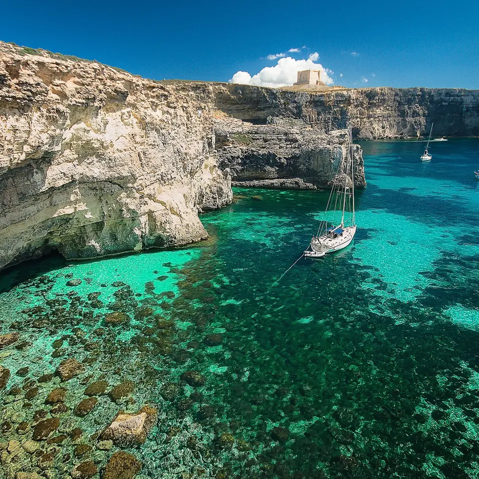 Clear turquoise water and a yacht at the Blue Lagoon.