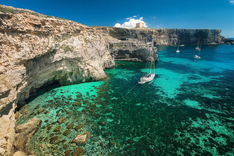 Clear turquoise water and a yacht at the Blue Lagoon.