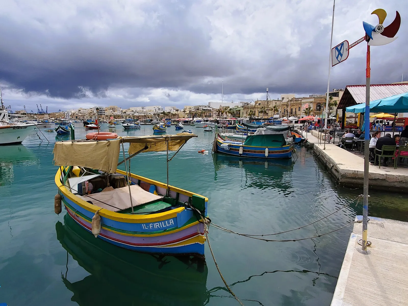 Painted luzzu boats across the harbour at Marsaxlokk.