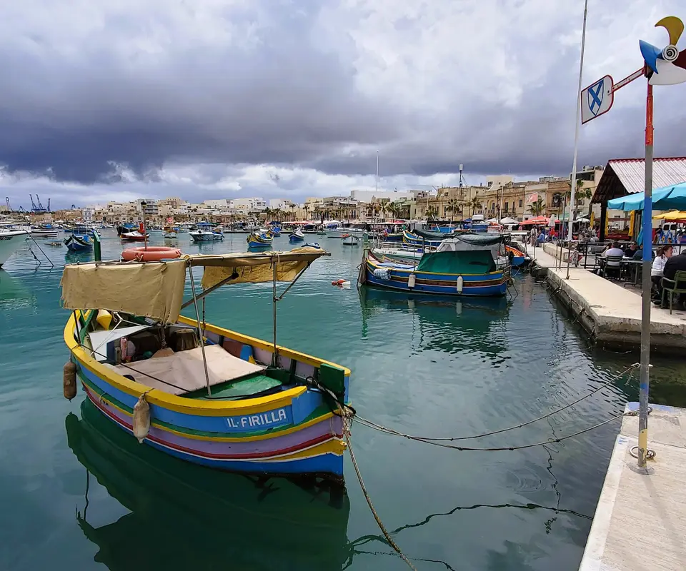 Painted luzzu boats across the harbour at Marsaxlokk.