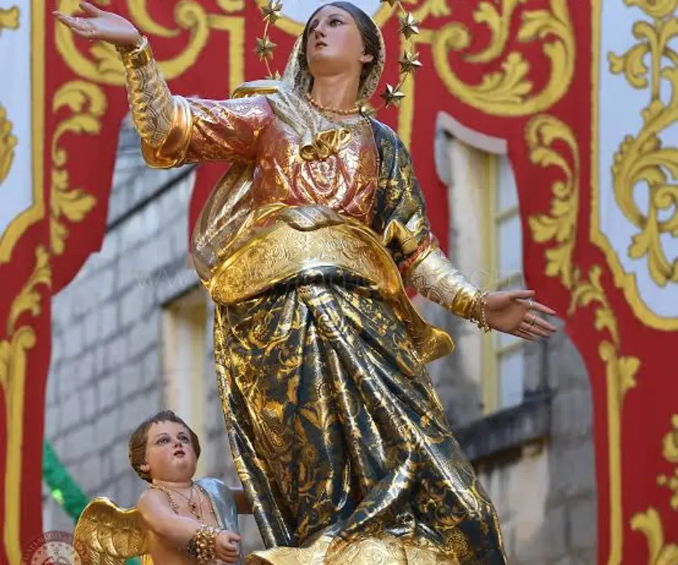 The original Santa Marija statue of Mqabba, photographed among the festa decorations.