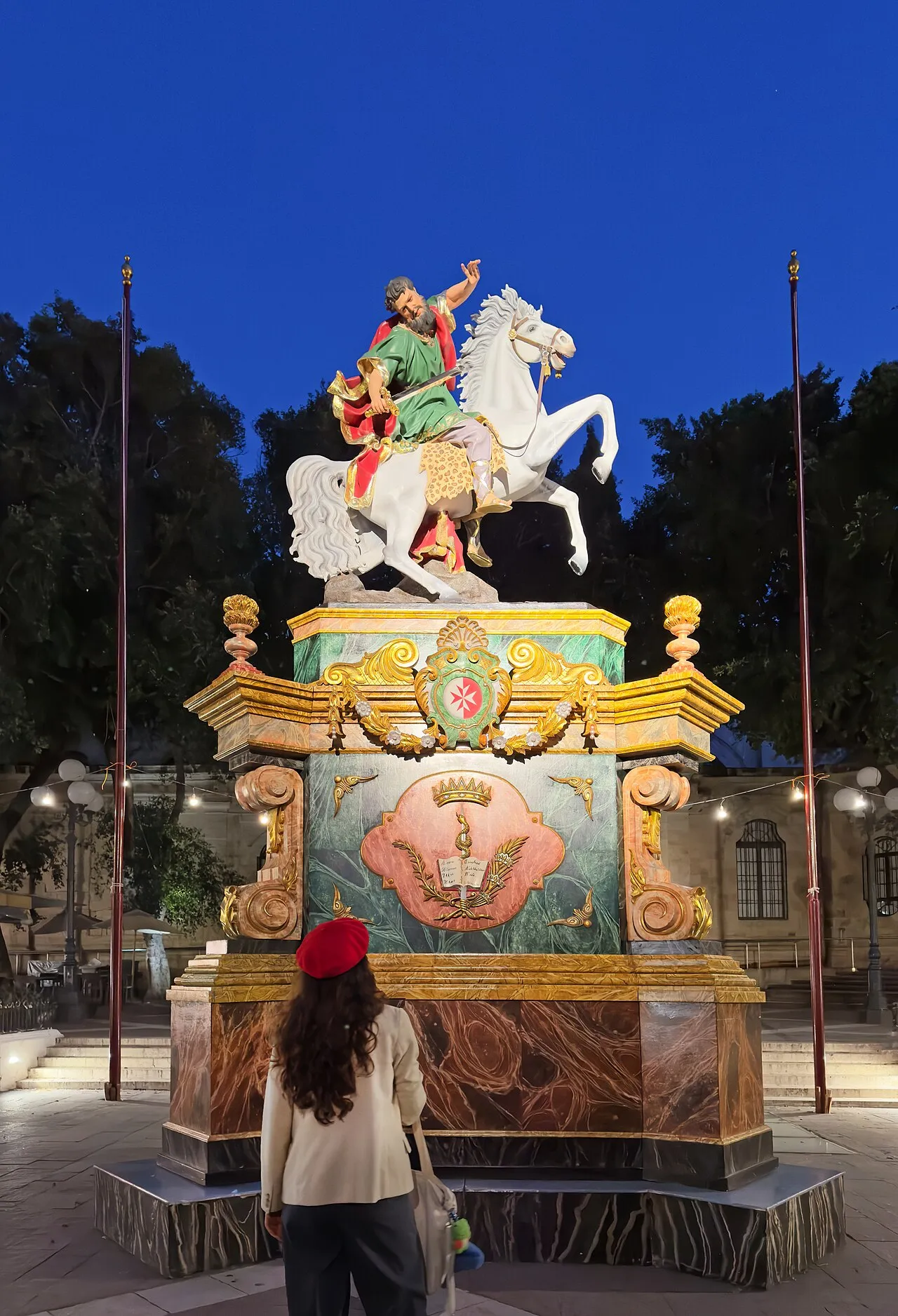 A quiet moment beside the statue of St Paul during the festa.